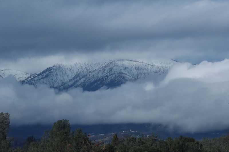 Clouds part over the mountains near Shasta Bally near Redding. Rain storms paused for a few minutes around noon on Saturday, Jan. 14, 2023.