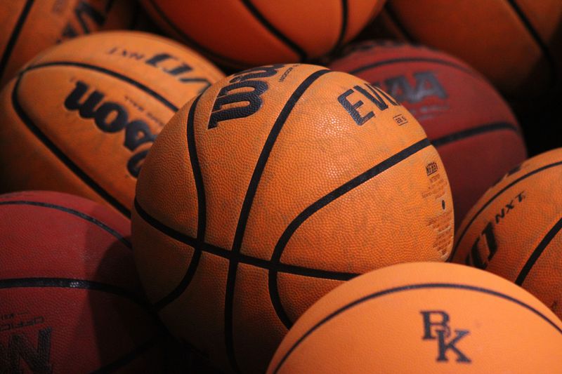 Basketballs rest beside the court before a high school girls basketball game in Jacksonville, Florida, between Bishop Kenny and Oakleaf on January 19, 2023. [Clayton Freeman/Florida Times-Union]