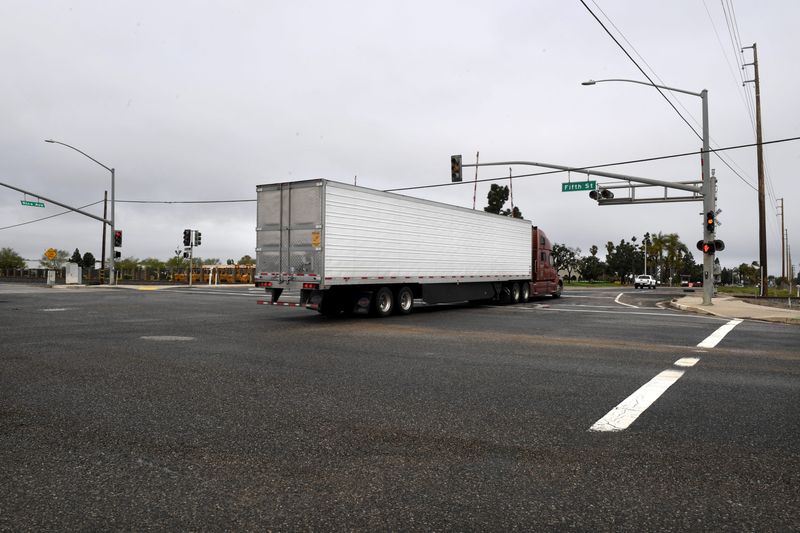 An 18-wheeler drives across railroad tracks along Fifth Street at the intersection with Rice Avenue in Oxnard on March 15, 2023. A $117 million bridge planned to carry vehicles over the dangerous crossing is expected to be complete in 2028.