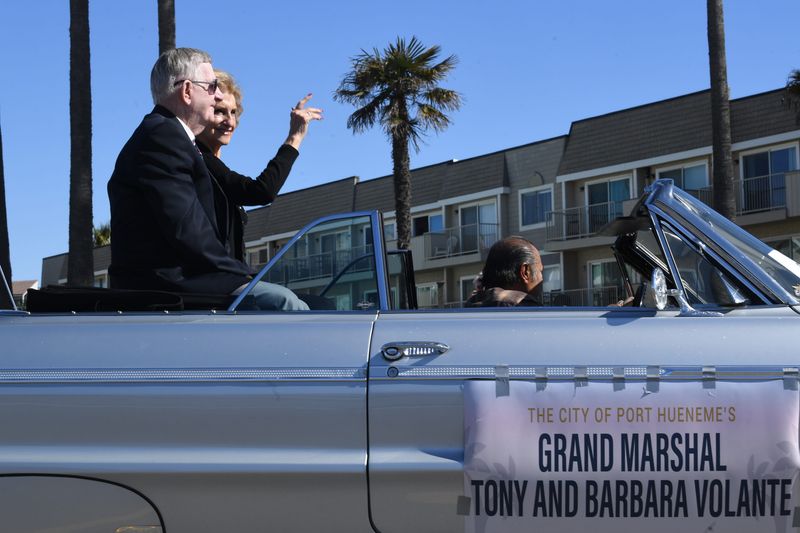 Tony and Barbara Volante, grand marshals for the city of Port Hueneme's 75th anniversary parade, wave to the audience along Surfside Drive in March 2023.