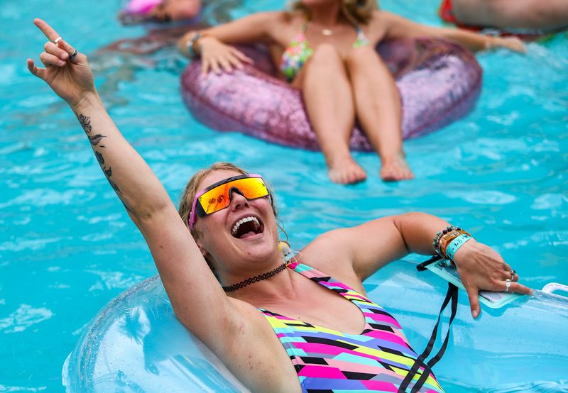 Sierra Annand of Philadelphia cheers while floating in the pool during a set by Hank K during Splash House at the Saguaro in Palm Springs, Calif., Saturday, June 10, 2023.