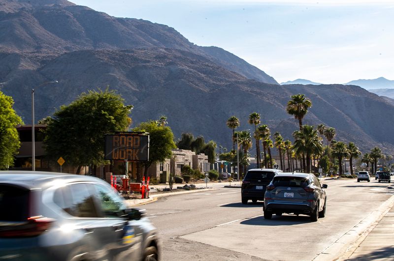 A road work sign is seen in the middle of Fred Waring Drive facing westbound traffic just past Monterey Avenue in Palm Desert, Calif., Wednesday, July 12, 2023.