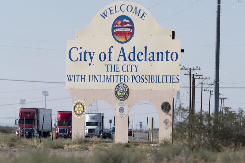 Traffic drives by the City of Adelanto's welcome sign on Highway 395 on Thursday. For the first time in six years, Adelanto's City Council passed a budget surplus. [James Quigg, Daily Press]