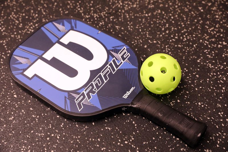 A pickleball paddle and wiffle ball at Solaris Sports Club in Yorktown Jan. 29 2019. Pickleball is a racquet sport that combines parts of tennis, badminton and ping pong.