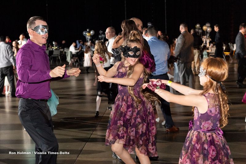 Girls from 4 to 15 years old and father figures dance during the annual Father-Daughter Dance at the Visalia Convention Center on Saturday, February 16, 2019. This year's theme was “Masquerade Ball,” and included music, dancing and refreshments.