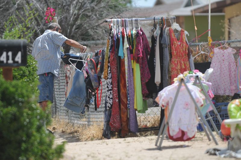 A man shops at a garage sale on Outer Hesperia Road in Victorville. Some Victorville yard sales seem to be skirting city regulations, city officials say.