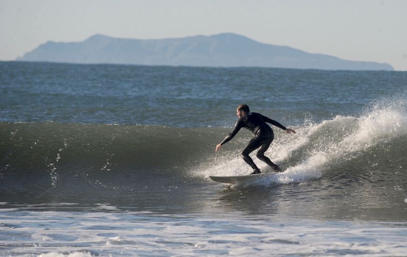 Bill Hickman, Southern California regional manager with Surfrider Foundation surfs king tides on Jan. 10, 2020, at Surfers Point to collect data on wave quality.