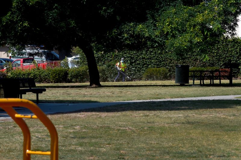A worker for Mariposa Landscapes uses a blower to collect fallen leaves at College Estates Park in Oxnard on Wednesday, August 25, 2021. With funding from Measure E, a sales tax increase approved by voters in November, the City of Oxnard is conducting maintenance in areas across the city.