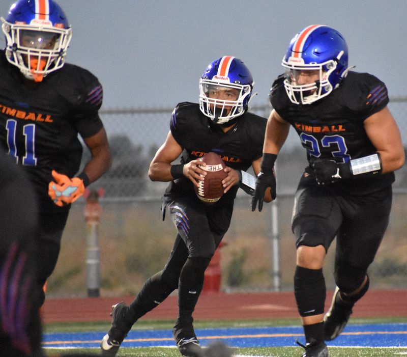 Kimball sophomore quarterback Josiah Wilson rolls out with blockers for a pass against Lincoln in their preseason home matchup against Lincoln.