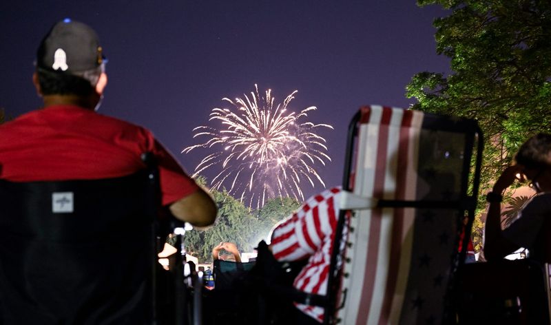 Paul Luevano, left, and his wife Neddie Valdez-Luevano watch fireworks Sunday, July 2, 2023 at Memorial Park in Exeter. Neddie's birthday is on the 4th.