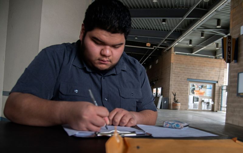 Datu Montilla of Stockton fills out a job application during the Stockton Ports' job fair at the Stockton Ballpark downtown Stockton on Mar. 3, 2024. The job fair was held to hire seasonal employees for positions including ticket scanners, concessions, ushers and others jobs ahead of the 2024 baseball season which starts on April 5. The Ports also held national anthem auditions on the same day which also was National anthem Day. Ports community relations manager James Cole can be reached for further auditions at jcole@stockotnports.com or (209) 644-1962.