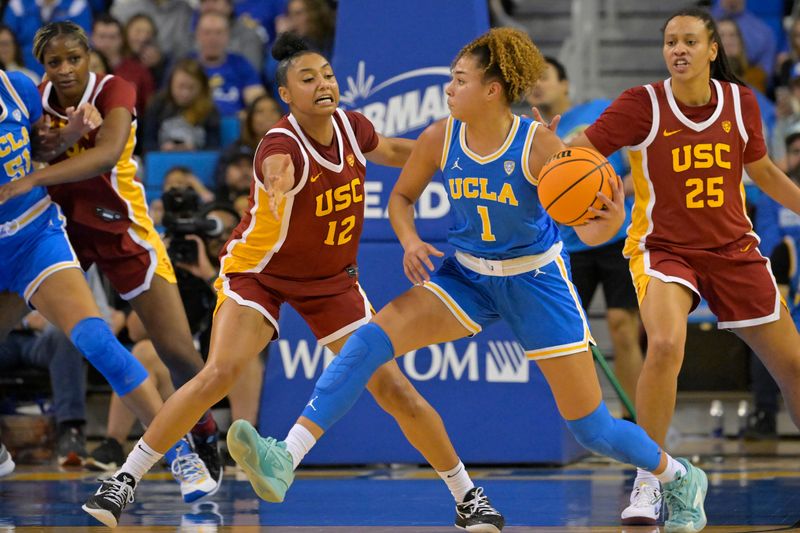 USC Trojans guard JuJu Watkins (12) defends UCLA Bruins guard Kiki Rice (1) in the second half at Pauley Pavilion presented by Wescom on Dec. 30, 2023 in Los Angeles, California.
