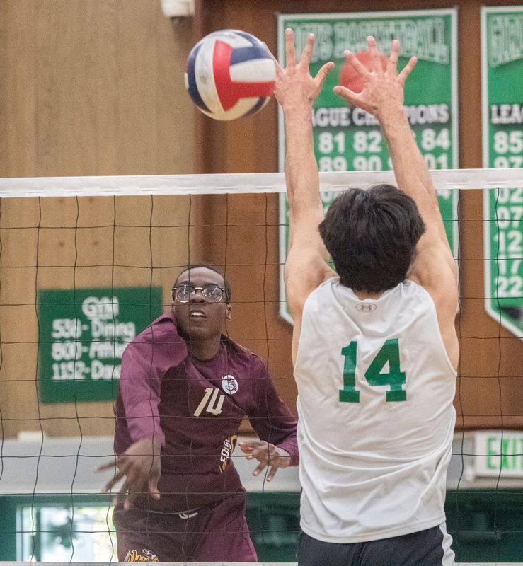 Edison's Rashad Lewis, left, spikes the ball on St. Mary's Vince Arnauto during a Sac-Joaquin Section boys volleyball playoff match at St. Mary's in Stockton on May. 2, 2024. St. Mary's won 3-1.