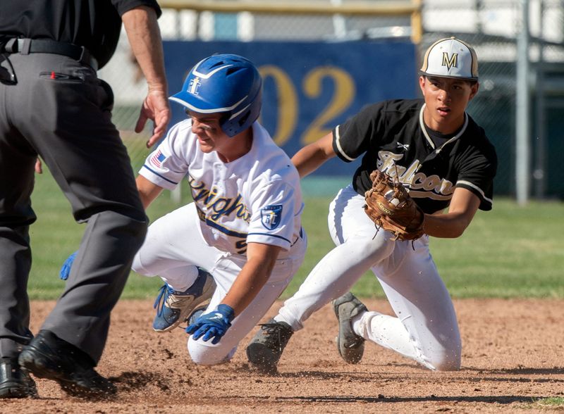 Ripon Christian's Noah DeBruyn, left, tagged out at second by Millennium's Julian Wells during a San Joaquin Section baseball playoff game at Ripon Christian High in Ripon on May 8, 2024.