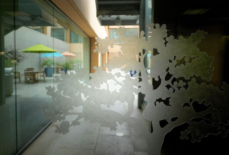 An oak tree emblem decorates glass by a patio on the third floor of the Thousand Oaks Civic Arts Plaza on Wednesday, May 15, 2024.