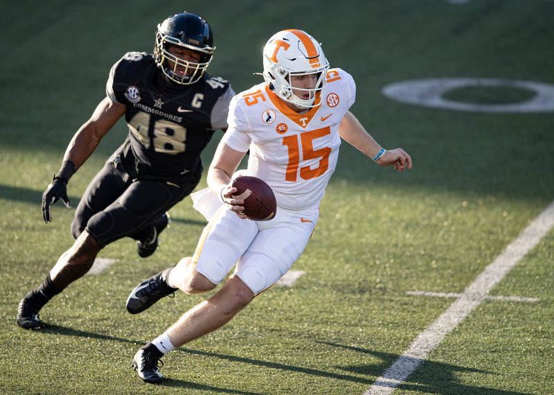 Tennessee quarterback Harrison Bailey (15) runs for yardage as he is chased by Vanderbilt linebacker Andre Mintze (48) during the first half of an NCAA college football game Saturday, Dec. 12, 2020, in Nashville, Tenn.