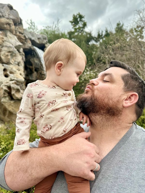 Apple Valley father Robert Blomker shares a loving embrace with his one-year-old daughter.