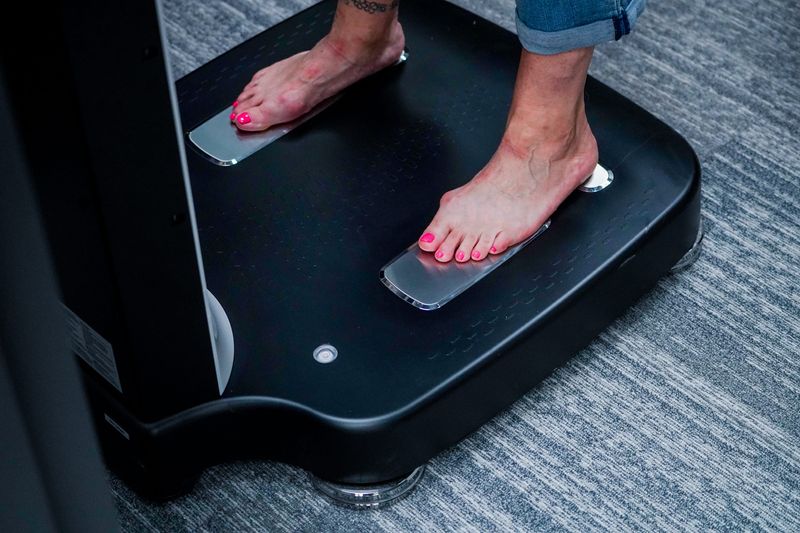 Premiere Weight Loss client Machaun Allen sneaks in a appointment before she and weight loss buddy Sherri Purdue (not shown) film a video testimony about their weight loss journey together on Wednesday, July 31, 2024 in Indianapolis. Here Allen stands of an a smart scale which asses body composition.