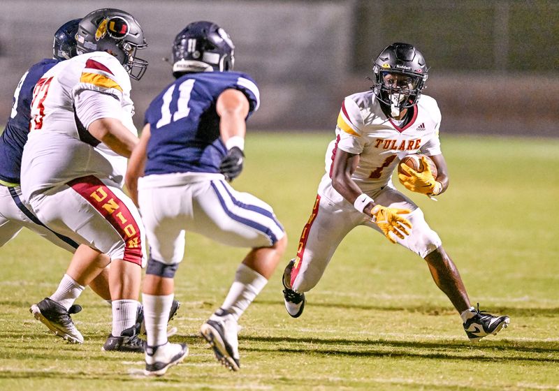 Tulare Union's Brayden Stevenson runs against Redwood in non-league high school football on Friday, September 6, 2024.