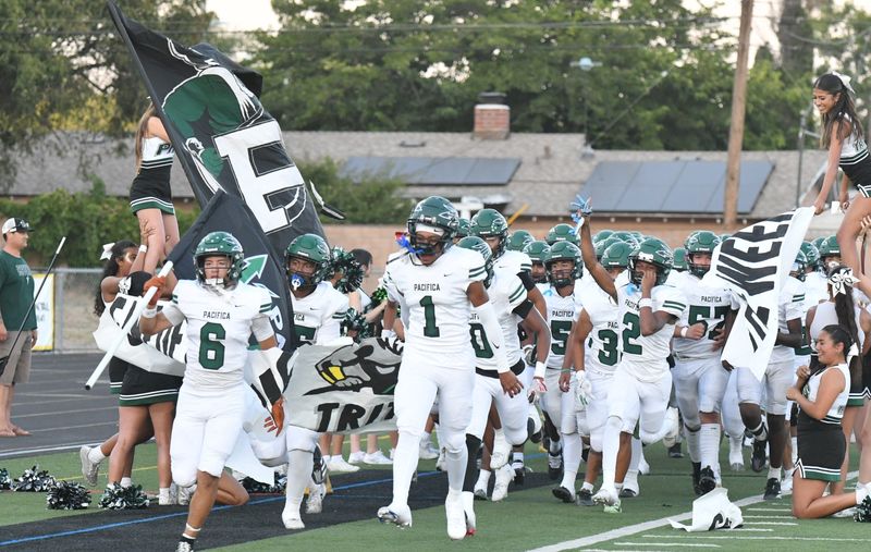 The Pacifica High football team races onto the field before the start of its game at Newbury Park High on Friday, Sept. 6, 2024. Newbury Park won, 36-3.