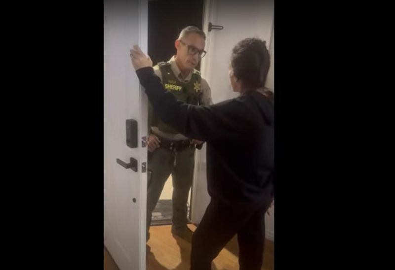 Adele Shirey confronts a Riverside County Sheriff's deputy in her home on July 4, 2024, in this image taken from a YouTube video.