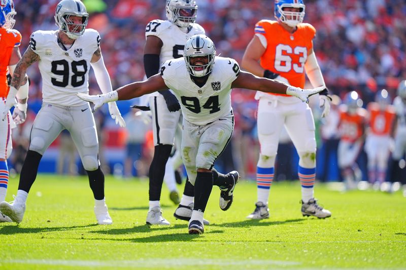 Oct 6, 2024; Denver, Colorado, USA; Las Vegas Raiders defensive tackle Christian Wilkins (94) celebrates his sack in the second quarter against the Denver Broncos at Empower Field at Mile High. Mandatory Credit: Ron Chenoy-Imagn Images