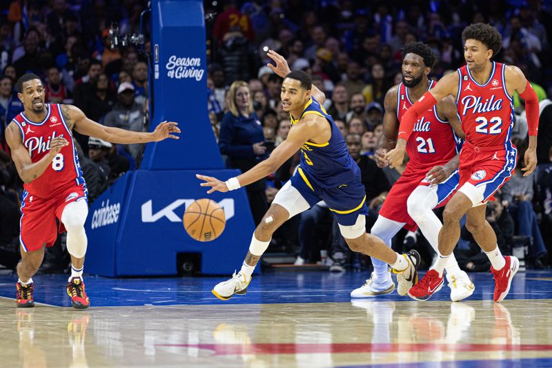 Dec 16, 2022; Philadelphia, Pennsylvania, USA; Golden State Warriors guard Jordan Poole (3) chases a loose ball between Philadelphia 76ers guard Matisse Thybulle (22) and guard De'Anthony Melton (8) during the third quarter at Wells Fargo Center. Mandatory Credit: Bill Streicher-USA TODAY Sports
