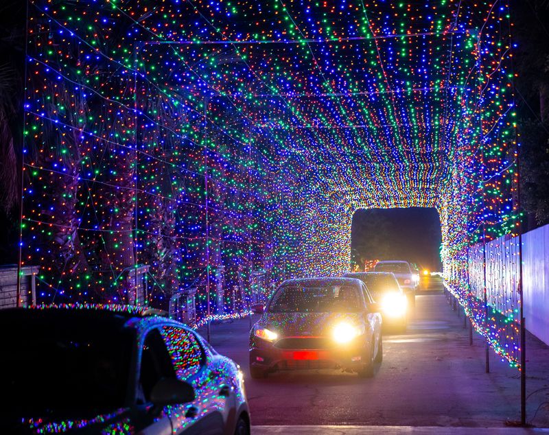 Cars pass through one of two light tunnels in the Magic of Lights show at the Empire Polo Club in Indio, Calif., Monday, Nov. 18, 2024.
