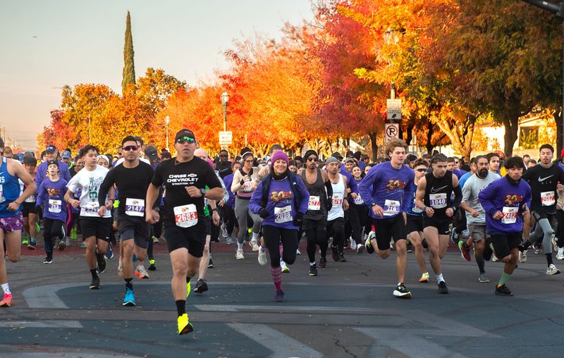 Runners take off at the start of the 20th annual Run/Walk Against Hunger on Fremont Street in front of the Stockton Ballpark in downtown Stockton on Nov. 28, 2024. More than 2900 people registered to participate in the 5/10K run, sponsored by the Aaron June AllRise Foundation, and raised funds for the Stockton/San Joaquin Emergency Food Bank.