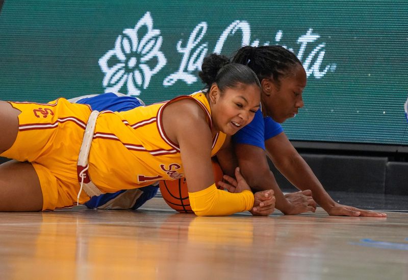 Malia Samuels, 10, of USC and Shun'teria Anumele of St. Louis University fight for a loose ball during the 2024 Acrisure Women's Holiday Invitational in Palm Desert, Calif., Nov. 29, 2024.