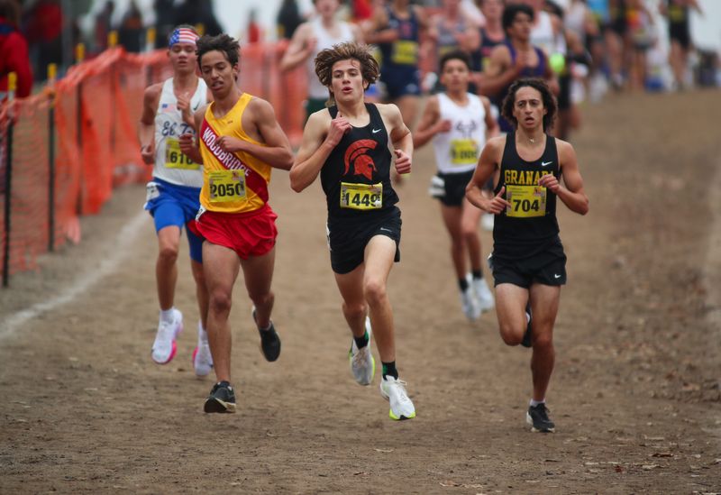 Rio Mesa's Derek Luna charges down a hill after the two-mile mark in the Division II boys race at the CIF State Cross Country Championships on Nov. 30, 2024, at Woodward Park in Fresno.