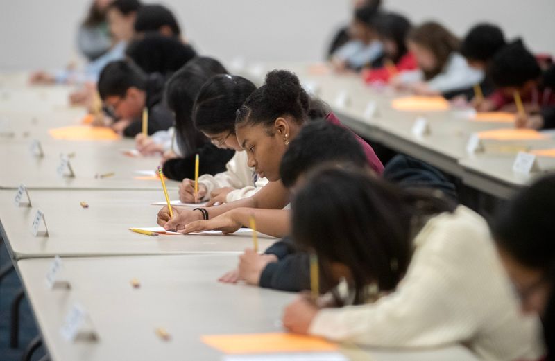 Competitors in the San Joaquin County junior division spelling bee write down their spellings to a word at the SJCOE’s Wentworth Educational Services Center in Stockton on Dec. 3, 2024. Forty-three 7th-9th grade students from 13 school districts around the county participated in the event.
