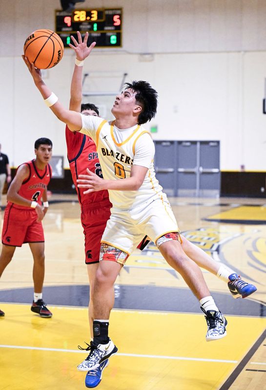 Golden West's Jayden Najera goes up for two against Strathmore's Isael Gutierrez in non-league boys basketball Wednesday, December 4, 2024.