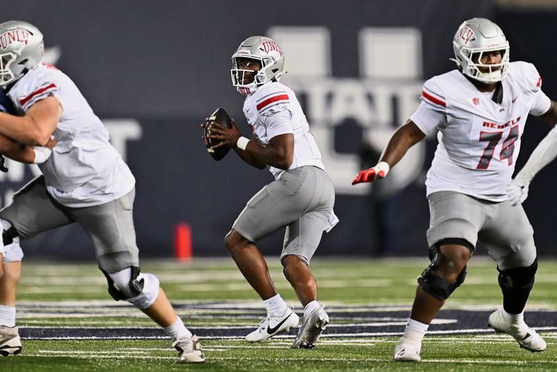Oct 11, 2024; Logan, Utah, USA; UNLV Rebels quarterback Hajj-Malik Williams (6) sets up to pass against the Utah State Aggies at Merlin Olsen Field at Maverik Stadium. Mandatory Credit: Jamie Sabau-Imagn Images