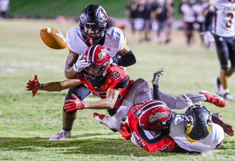 Tulare Union's Keanu Kennedy and Hanford's Elijah Felder scramble for a loose ball near the end zone in West Yosemite League football Friday, October 11, 2024.