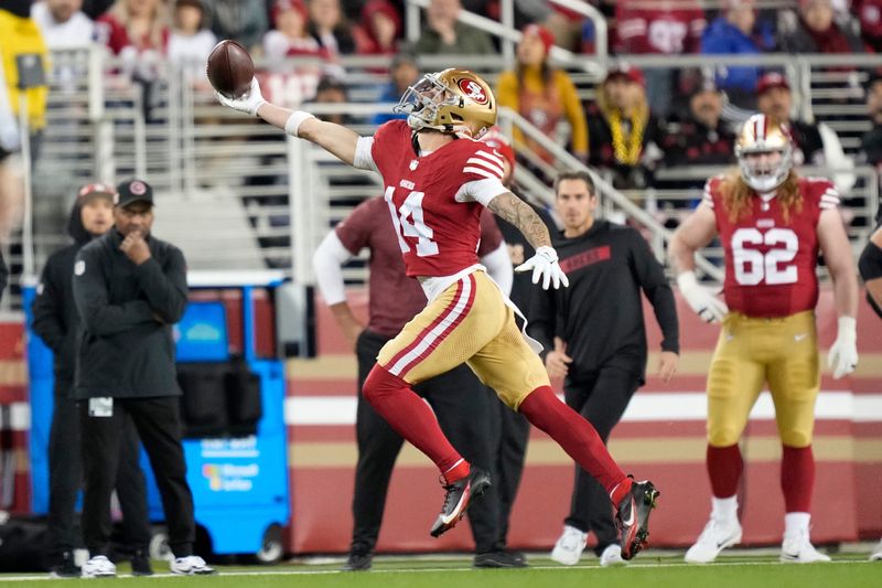 December 30, 2024; Santa Clara, California, USA; San Francisco 49ers wide receiver Ricky Pearsall (14) catches the football against the Detroit Lions during the first quarter at Levi's Stadium. Mandatory Credit: Kyle Terada-Imagn Images