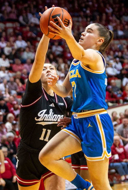 UCLA's Elina Aarnisalo (7) is blocked by Indiana's Karoline Striplin (11) during the Indiana versus UCLA women's game at Simon Skjodt Assembly Hall on Saturday, Jan. 4, 2025.