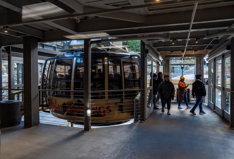 Riders step off the Palm Springs Aerial Tramway in Palm Springs, Calif., Tuesday, Jan. 7, 2025.