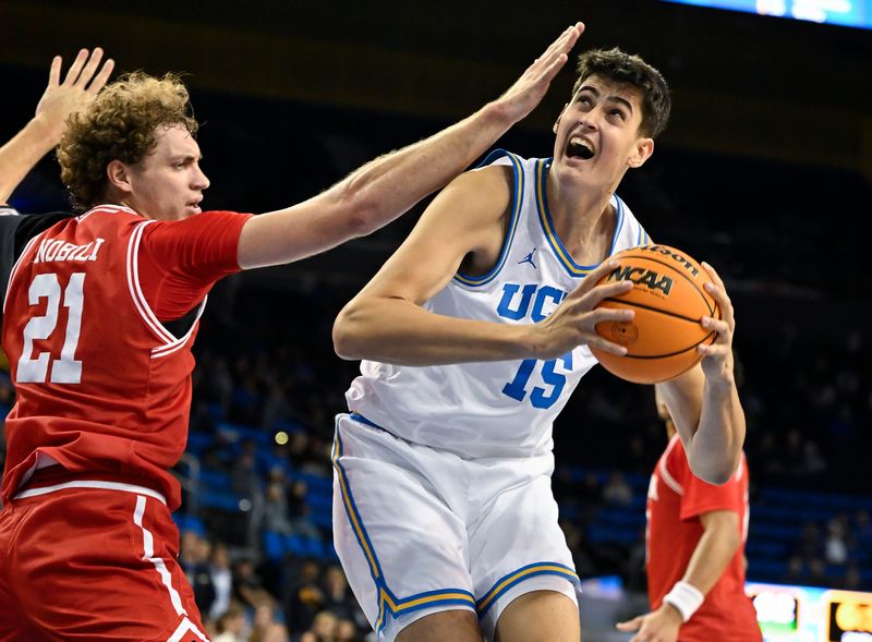 Nov 11, 2024; Los Angeles, California, USA; UCLA Bruins center Aday Mara (15) drives to the basket on Boston University Terriers forward Nico Nobili (21) during the second half at Pauley Pavilion presented by Wescom. Mandatory Credit: Robert Hanashiro-Imagn Images