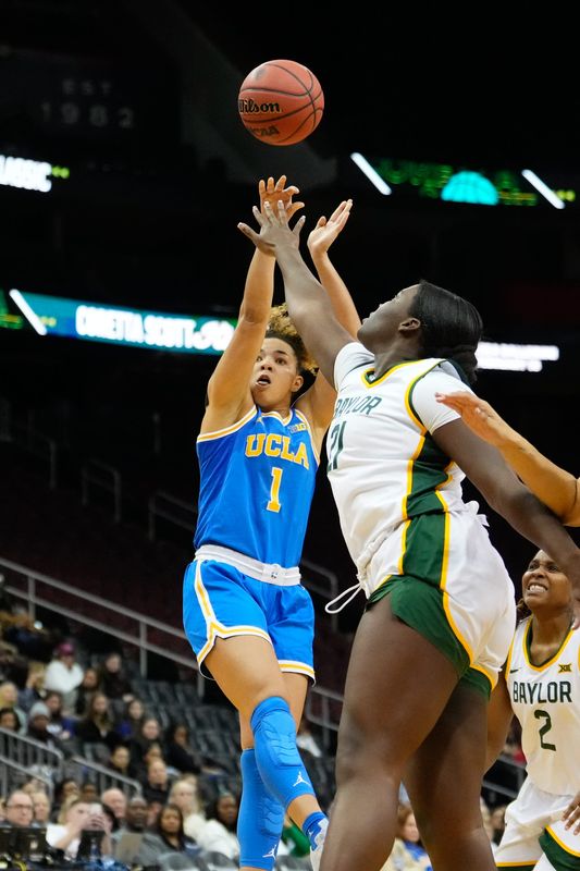 Jan 20, 2025; Newark, New Jersey, USA; UCLA Bruins guard Kiki Rice (1) scores a basket against Baylor Lady Bears center Aaronette Vonleh (21) during the second half at Prudential Center. Mandatory Credit: Chris Jones-Imagn Images