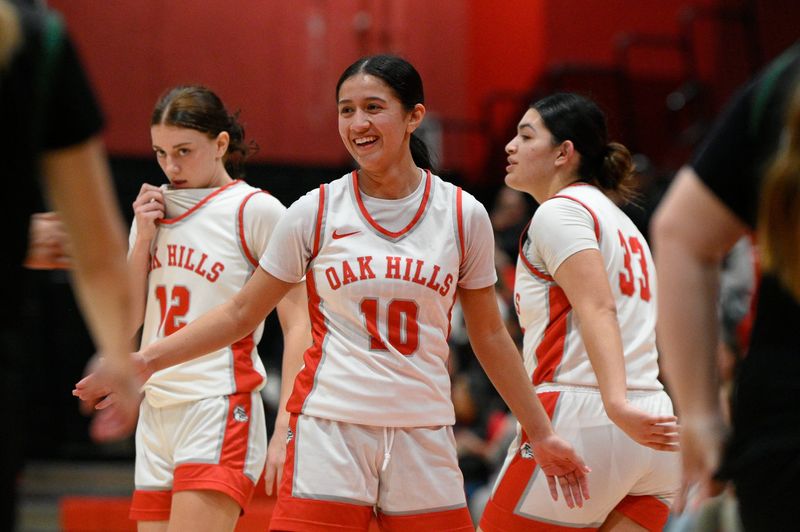 Oak Hills’ Bella Rincon celebrates with a teammate as the clock winds down with a six point lead over Burroughs during the fourth quarter of the game on Thursday, January 30, 2025 in Hesperia. Oak Hills defeated Burroughs 49-43 to claim the Mojave River League title.