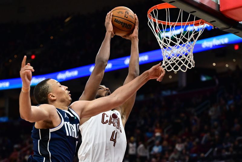 Feb 2, 2025; Cleveland, Ohio, USA; Cleveland Cavaliers forward Evan Mobley (4) dunks against Dallas Mavericks guard Dante Exum (0) during the second half at Rocket Mortgage FieldHouse. Mandatory Credit: Ken Blaze-Imagn Images