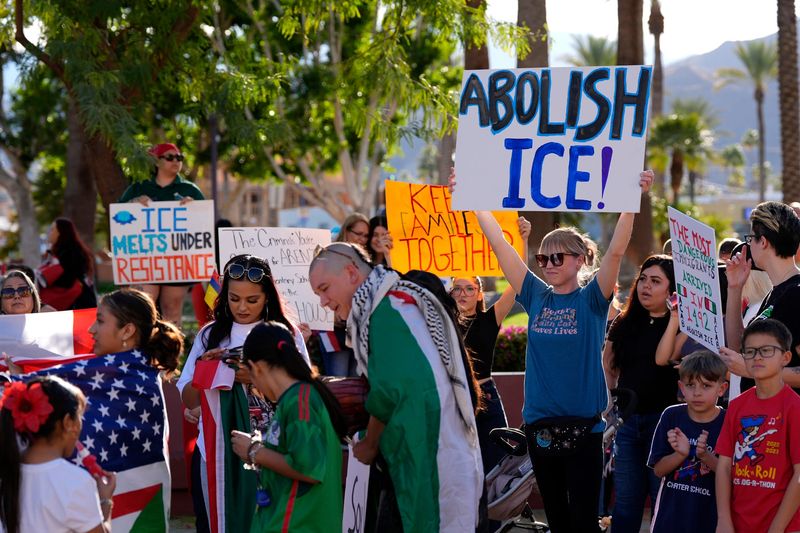 Kara Wahlin of Palm Desert holds a sign saying 'Abolish Ice!' while protesting President Trump's immigration policies in downtown Cathedral City, Calif., on Wednesday, Feb. 5, 2025.