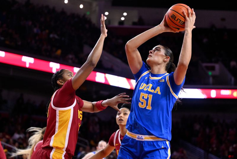 Feb 13, 2025; Los Angeles, California, USA; UCLA Bruins center Lauren Betts (51) shoots over USC Trojans guard Aaliyah Gayles (3) during the first quarter at Galen Center. Mandatory Credit: Robert Hanashiro-Imagn Images