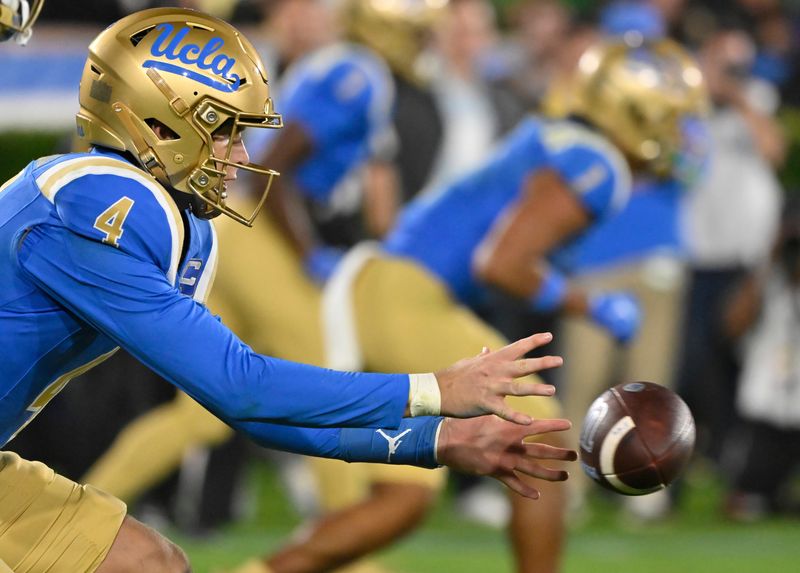 Sep 28, 2024; Pasadena, California, USA; UCLA Bruins quarterback Ethan Garbers (4) takes a snap during the third quarter against the Oregon Ducks at Rose Bowl. Mandatory Credit: Robert Hanashiro-Imagn Images