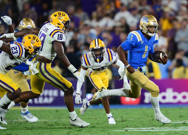 Sep 4, 2021; Pasadena, California, USA; UCLA Bruins quarterback Dorian Thompson-Robinson (1) runs the ball against the Louisiana State Tigers defense during the second half the at the Rose Bowl. Mandatory Credit: Gary A. Vasquez-USA TODAY Sports
