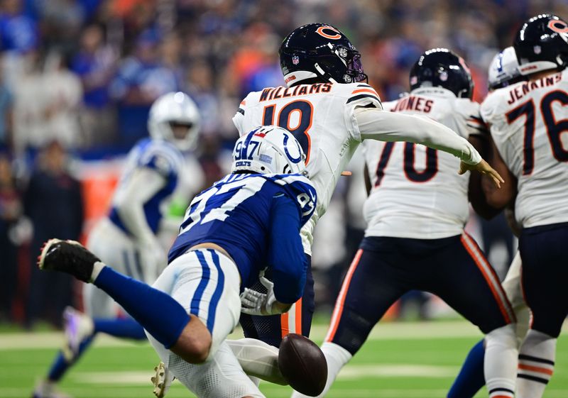 Sep 22, 2024; Indianapolis, Indiana, USA; Indianapolis Colts defensive end Laiatu Latu (97) knocks the ball away from Chicago Bears quarterback Caleb Williams (18) during the second half at Lucas Oil Stadium. Mandatory Credit: Marc Lebryk-Imagn Images