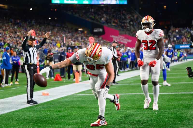 Oct 10, 2024; Seattle, Washington, USA; San Francisco 49ers tight end George Kittle (85) spikes the ball after scoring a touchdown against the Seattle Seahawks during the second half at Lumen Field. Mandatory Credit: Steven Bisig-Imagn Images