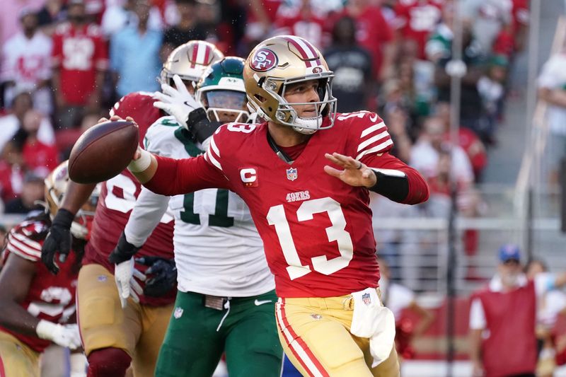 Sep 9, 2024; Santa Clara, California, USA; San Francisco 49ers quarterback Brock Purdy (13) throws a pass during the second quarter while pursued by New York Jets linebacker Jermaine Johnson (11) at Levi's Stadium. Mandatory Credit: David Gonzales-Imagn Images