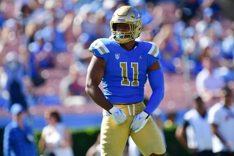 Oct 7, 2023; Pasadena, California, USA; UCLA Bruins defensive lineman Gabriel Murphy (11) celebrates after sacking Washington State Cougars quarterback Cameron Ward (1) during the second half at Rose Bowl. Mandatory Credit: Gary A. Vasquez-USA TODAY Sports